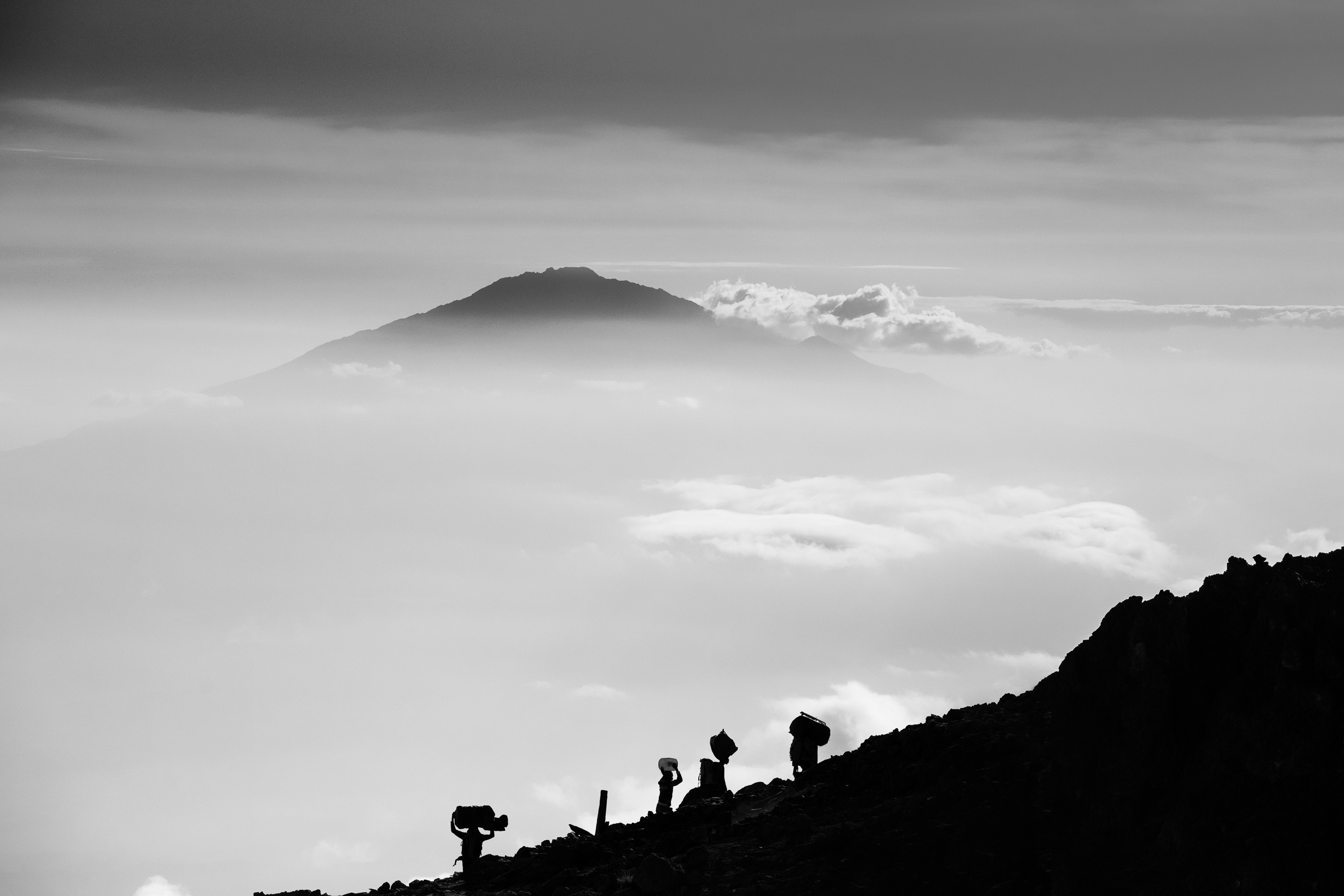 Porters carrying supplies up the mountain