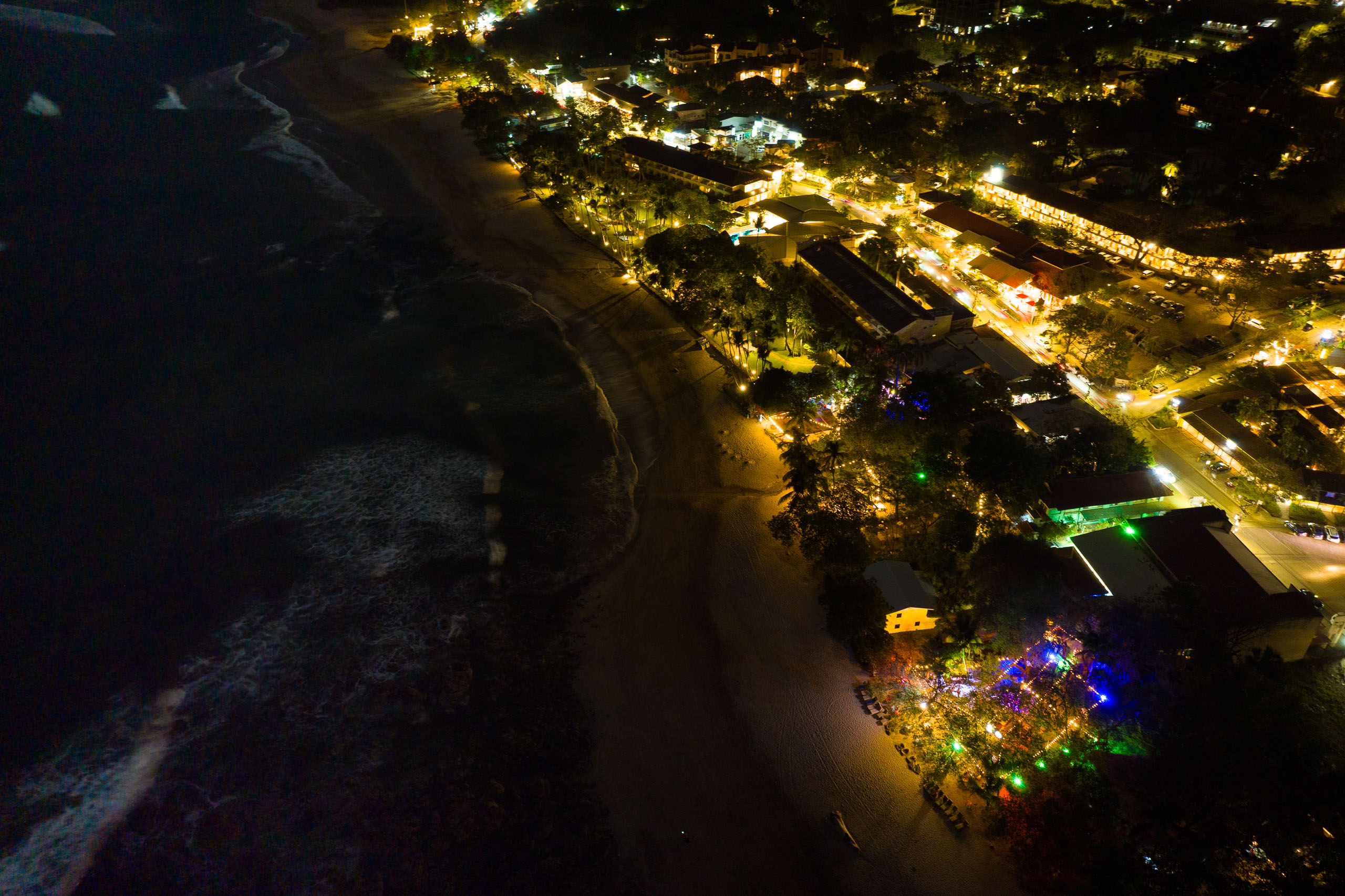 Light pollution flooding a beach from coastal development