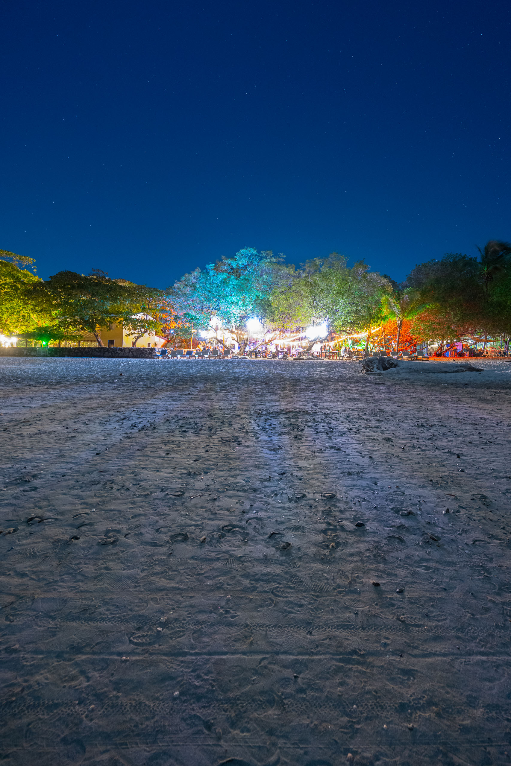 A developed beach from the air with artificial light drowning stars